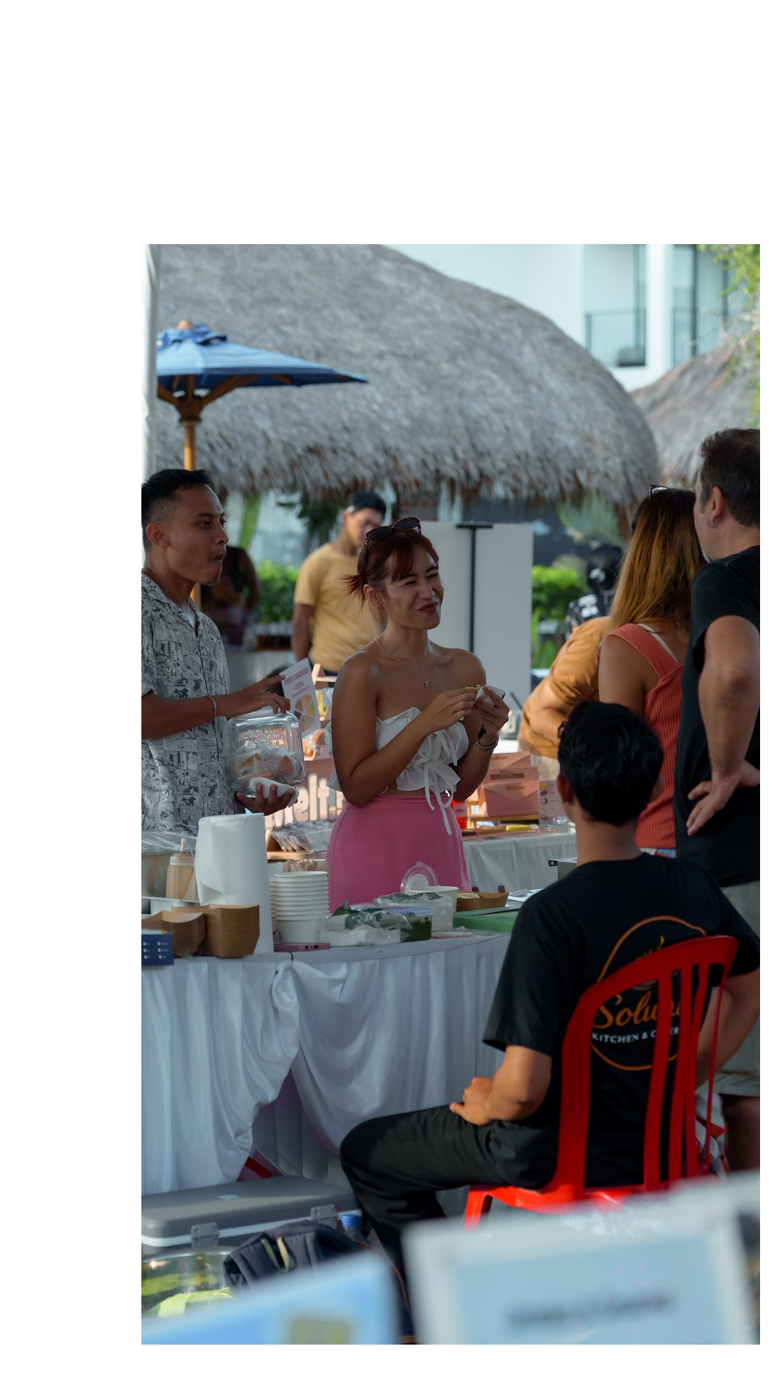 Vendor serving guests at a market stall