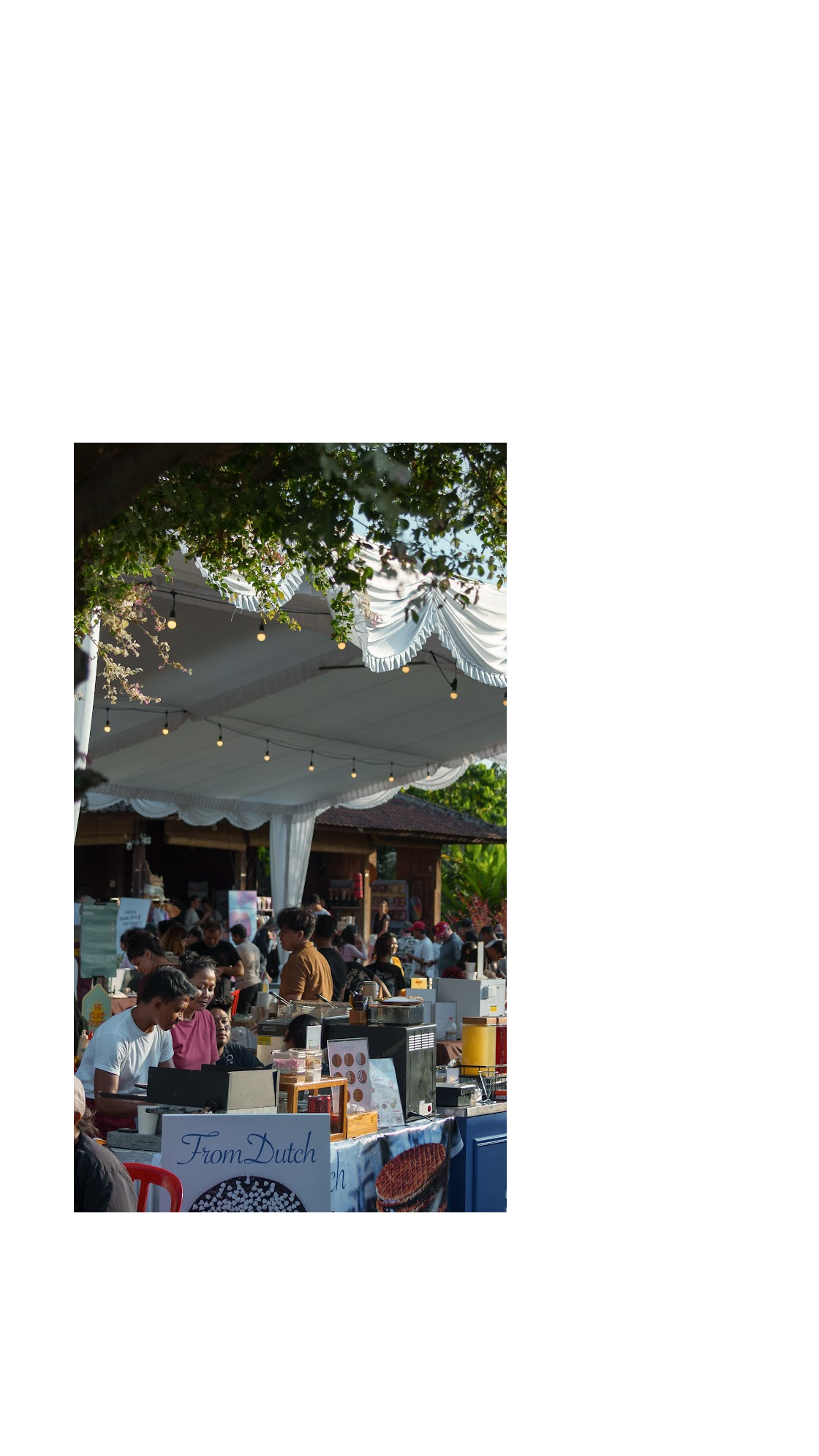 Busy outdoor food stalls beneath a shaded canopy